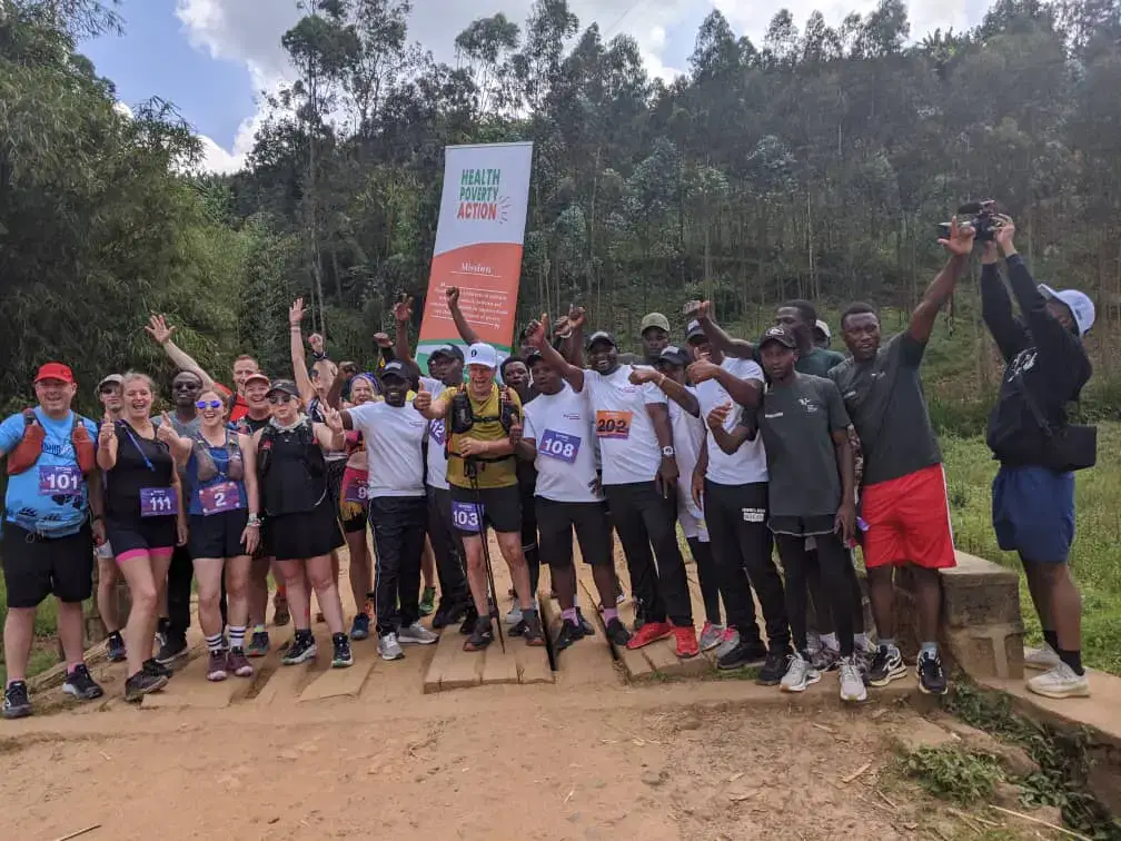 A large group of runners standing together celebrating in Rwanda.