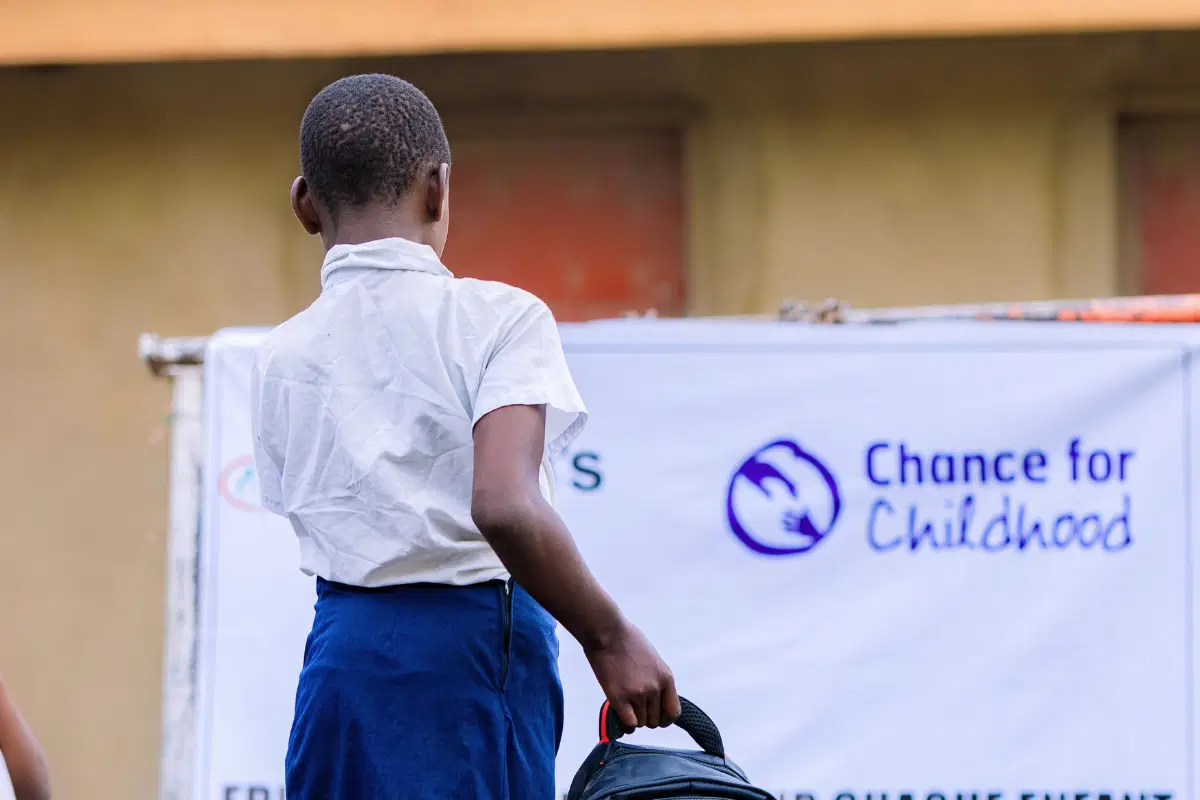 African child young girl carrying a backpack.